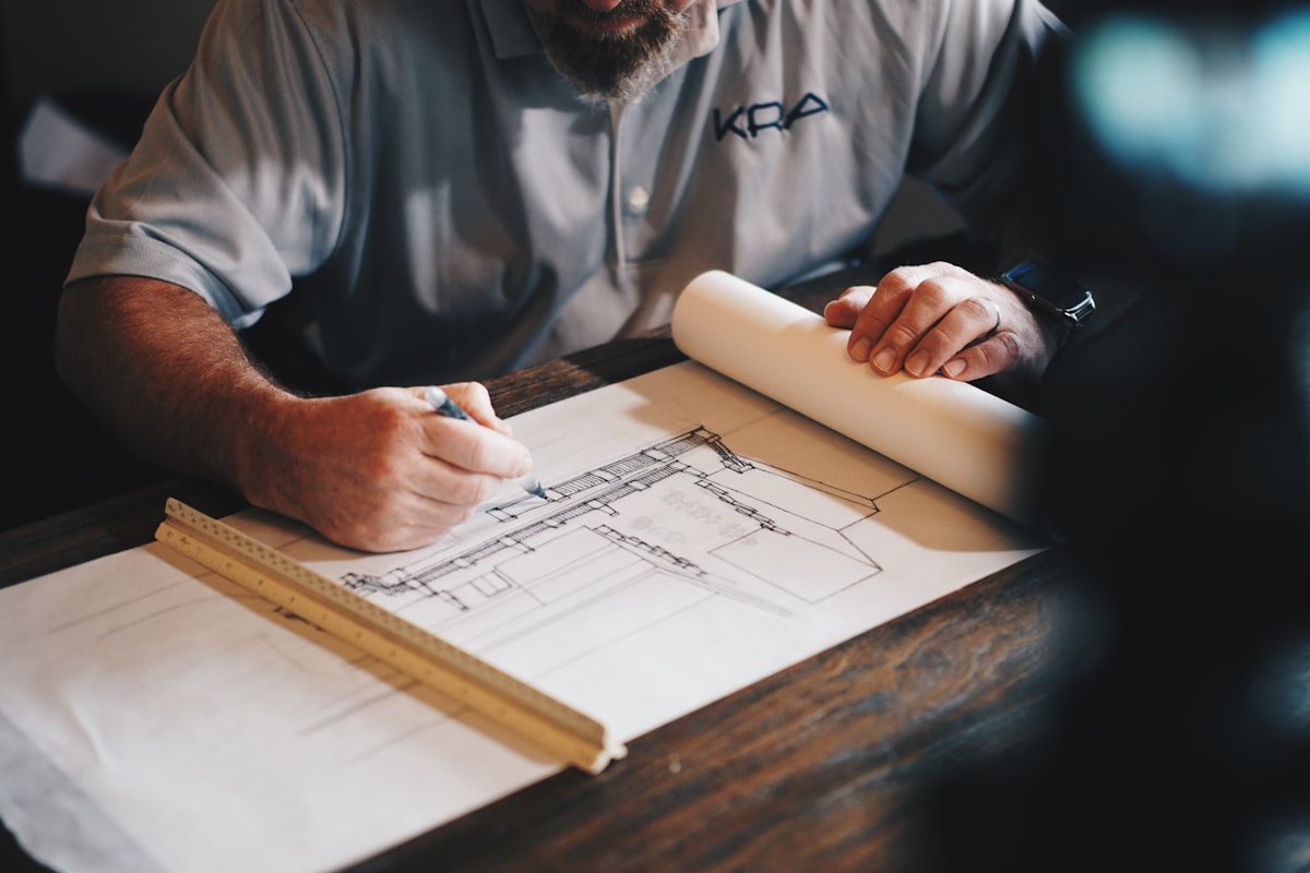 Gerente de obra revisando presupuestos y avance de proyecto en Odoo ERP, con estructura de construcción al fondo